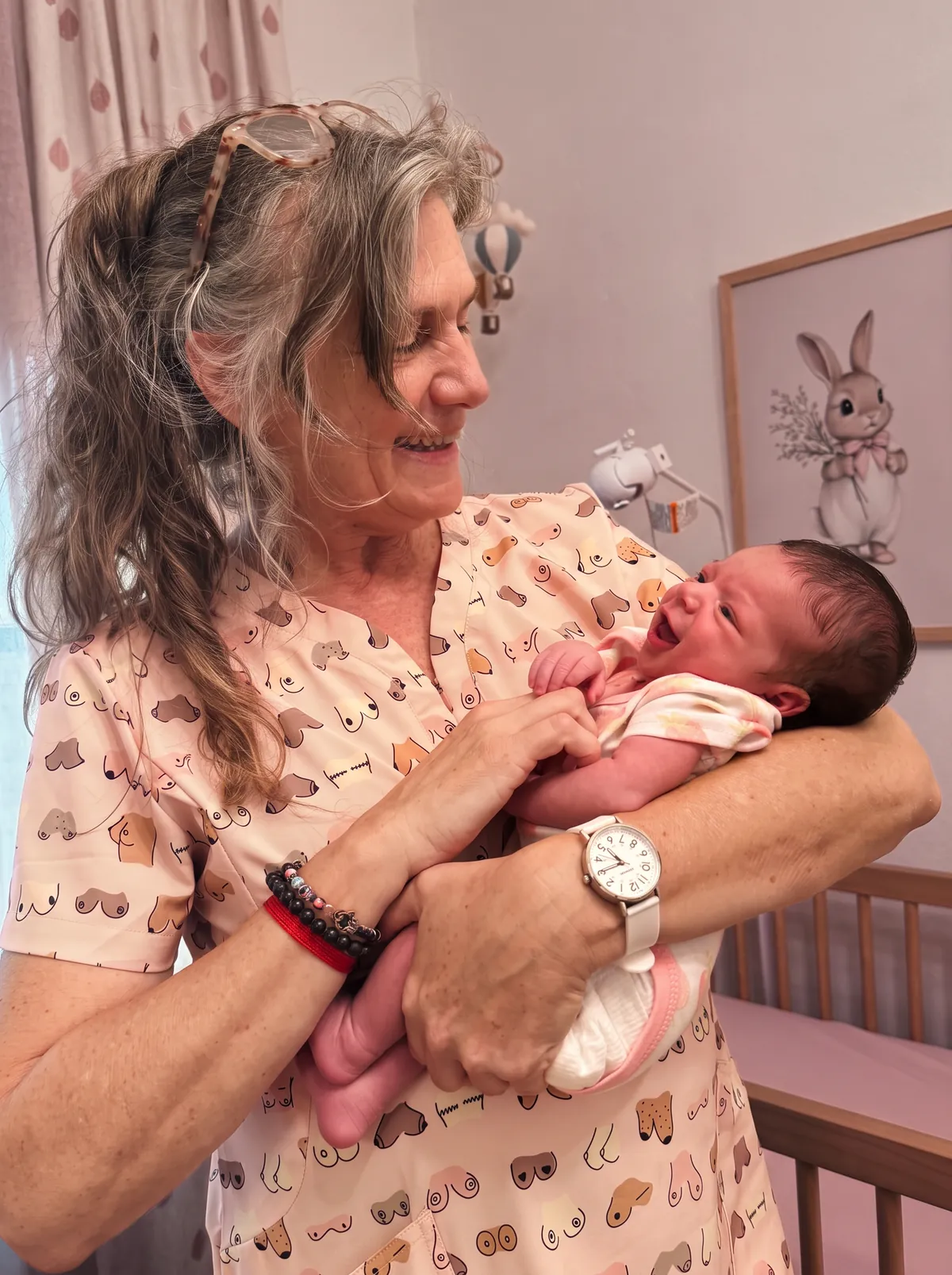Marina Langesfeld, IBCLC lactation consultant in Miami, holding a newborn